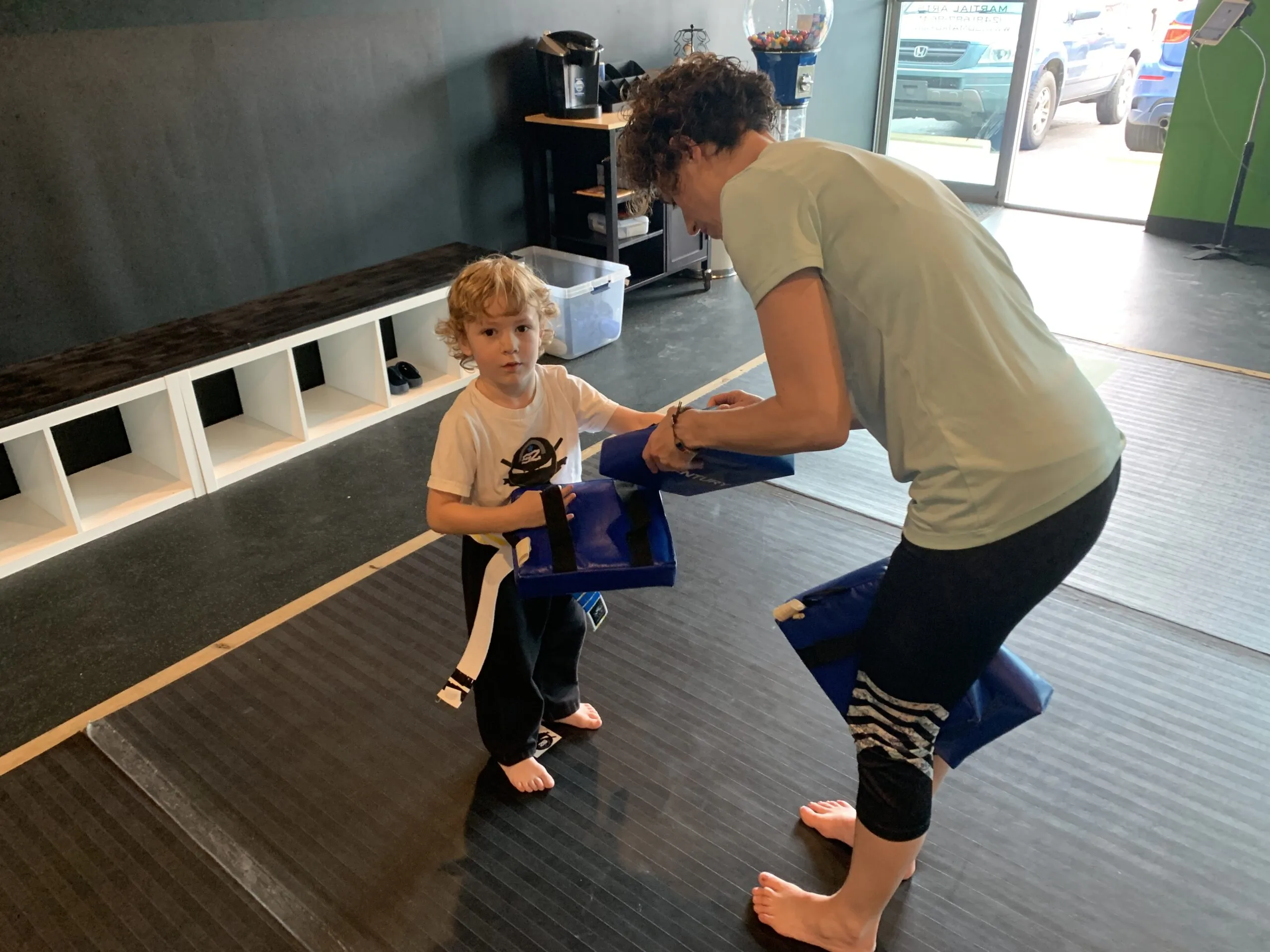 young boy getting ready for karate with his mom