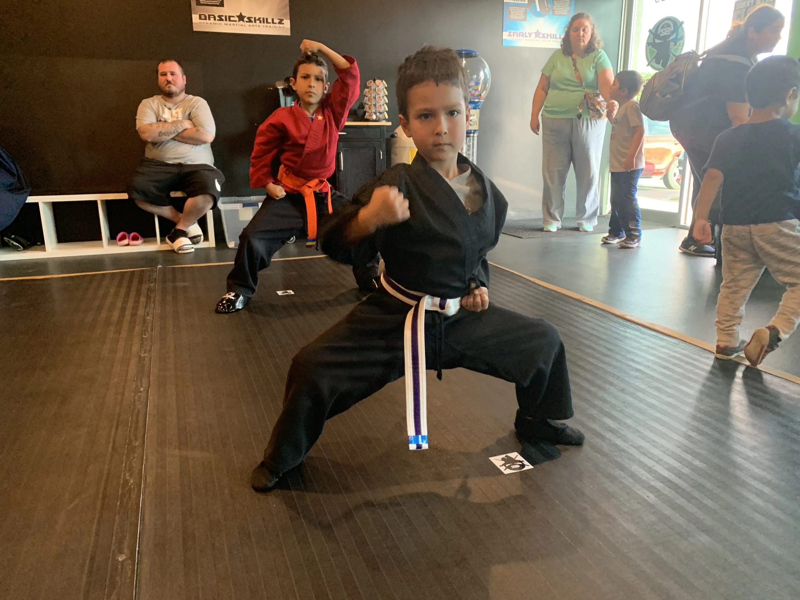 a young boy in karate class in a horse stance