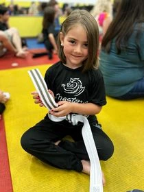 karate girl showing her belt with stripes karate girl showing her belt with stripes