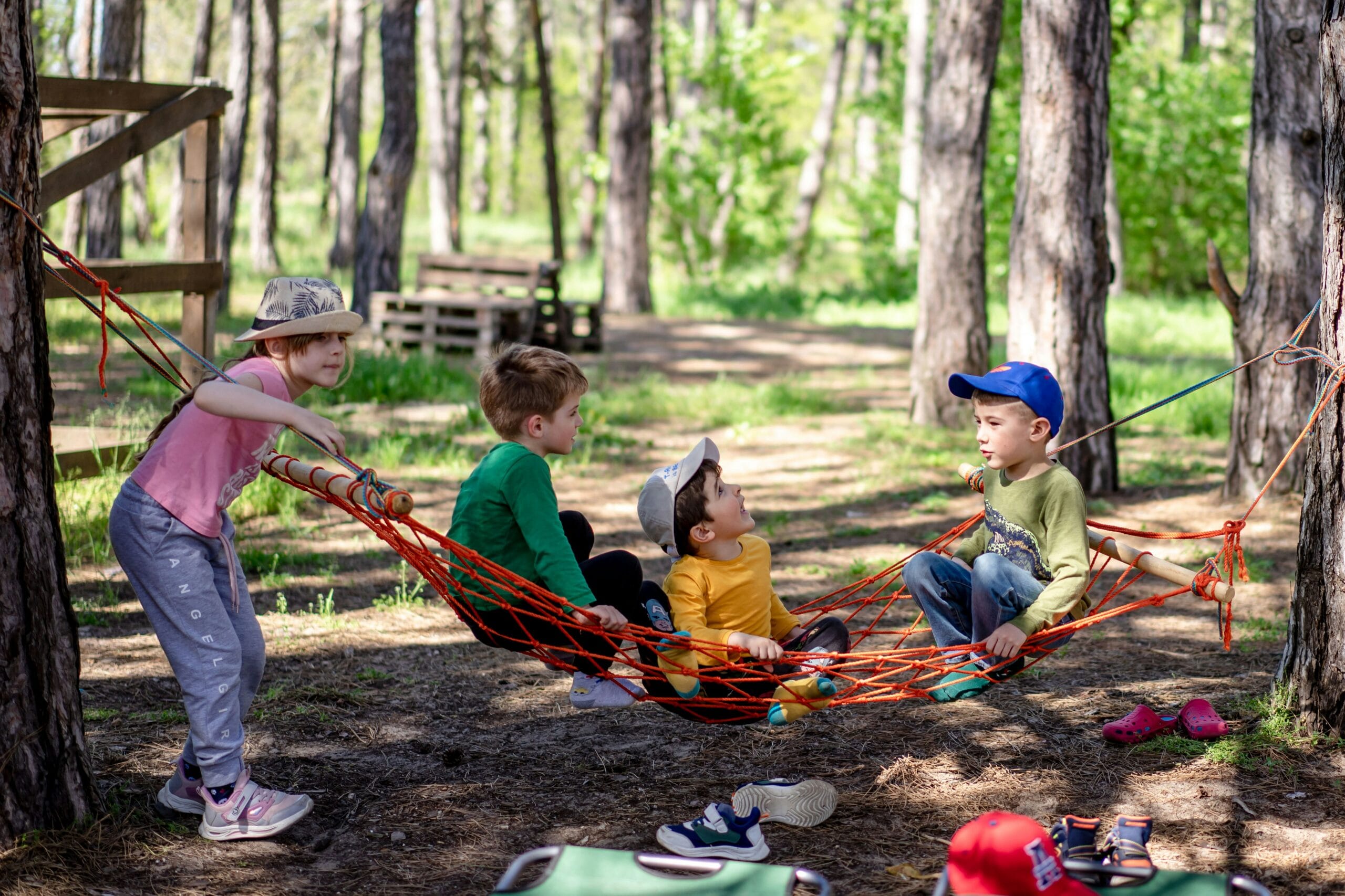 kids in the woods playing on rope hammock kids in the woods playing on rope hammock